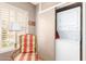 Laundry room includes stacked washer and dryer, window with shutters, and chair at 2201 N Central Ave # 3D, Phoenix, AZ 85004