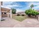 Backyard featuring a grass lawn, privacy wall, and a covered patio at 231 N Nash Way, Chandler, AZ 85225
