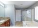 Bathroom featuring glass enclosed shower, garden tub, vanity and framed mirror at 231 N Nash Way, Chandler, AZ 85225