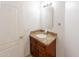 Bathroom vanity with wood cabinets, granite countertop, framed mirror and lighting fixture at 231 N Nash Way, Chandler, AZ 85225