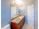 Bright bathroom featuring a granite countertop and a well-lit mirror at 231 N Nash Way, Chandler, AZ 85225