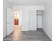 Cozy bedroom featuring wood floors, closet, and bathroom access at 231 N Nash Way, Chandler, AZ 85225