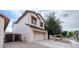 Home exterior featuring an attached two-car garage, stucco finish, and mature trees in a well-maintained neighborhood at 231 N Nash Way, Chandler, AZ 85225