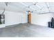 Attached garage showcasing clean walls, storage, and water heater at 231 N Nash Way, Chandler, AZ 85225
