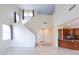 Bright living room with soaring ceilings, tile floors, and open access to a kitchen with stained cabinets at 231 N Nash Way, Chandler, AZ 85225