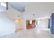 Bright living room with soaring ceilings and tile flooring, seamlessly flowing into an open-concept kitchen at 231 N Nash Way, Chandler, AZ 85225