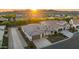 Stunning aerial view of a modern home in a desert community with beautiful landscaping and mountain views at sunset at 3020 N 165Th Ave, Goodyear, AZ 85395