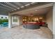 Cozy covered patio features a circular lounge set, travertine tile flooring, and outdoor dining at 3020 N 165Th Ave, Goodyear, AZ 85395