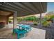 Covered patio featuring an outdoor dining set with desert landscaping at 3020 N 165Th Ave, Goodyear, AZ 85395
