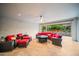 Comfortable covered patio featuring a lounge set with red cushions and view to a garden at 3020 N 165Th Ave, Goodyear, AZ 85395