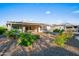 Expansive backyard featuring a covered patio and thoughtfully arranged desert landscaping with native plants at 3020 N 165Th Ave, Goodyear, AZ 85395