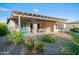 Inviting backyard with a covered patio, outdoor seating, desert landscaping, and a bright blue picnic table at 3020 N 165Th Ave, Goodyear, AZ 85395