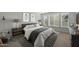 Bedroom featuring a large bed, lamps, side tables, and plenty of natural light at 3020 N 165Th Ave, Goodyear, AZ 85395