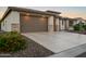Charming desert home with a spacious driveway and attractive landscaping with flowering plants at 3020 N 165Th Ave, Goodyear, AZ 85395