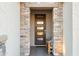 Inviting front door with stone accents, sidelights, and a cozy sitting area at 3020 N 165Th Ave, Goodyear, AZ 85395