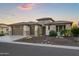 Beautiful home featuring a three-car garage, stone accents, and desert landscaping at 3020 N 165Th Ave, Goodyear, AZ 85395