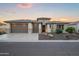 Beautiful home featuring a three-car garage, stone accents, and desert landscaping at 3020 N 165Th Ave, Goodyear, AZ 85395