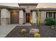 Striking home exterior with stone accents, desert landscaping, and a modern front door at 3020 N 165Th Ave, Goodyear, AZ 85395