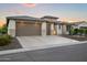 Beautiful home featuring a three-car garage, stone accents, and desert landscaping at 3020 N 165Th Ave, Goodyear, AZ 85395