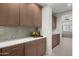 Kitchen features wood cabinets, white quartz countertops, and decorative tile backsplash at 3020 N 165Th Ave, Goodyear, AZ 85395
