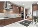 Close-up of a kitchen with stainless steel range hood, backsplash, and double ovens at 3020 N 165Th Ave, Goodyear, AZ 85395