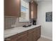 A cozy kitchen with a window, a coffee maker, and nice cabinetry at 3020 N 165Th Ave, Goodyear, AZ 85395