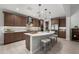 Modern kitchen with a large island, stainless steel appliances, and pendant lighting at 3020 N 165Th Ave, Goodyear, AZ 85395