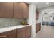 Butlers pantry features custom wood cabinets and countertops at 3020 N 165Th Ave, Goodyear, AZ 85395