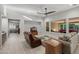 Bright open-concept living room boasts tile floors, a ceiling fan, and sliding glass doors to the back yard at 3020 N 165Th Ave, Goodyear, AZ 85395