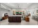 Bright open-concept living room boasts tile floors, a ceiling fan, and sliding glass doors to the back yard at 3020 N 165Th Ave, Goodyear, AZ 85395