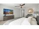 Comfortable primary bedroom with calming decor, decorative mirror, and a large-screen TV for relaxation at 3020 N 165Th Ave, Goodyear, AZ 85395