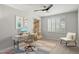 Bright home office featuring modern decor, stylish desk, comfortable chair, and natural light from shuttered windows at 3020 N 165Th Ave, Goodyear, AZ 85395