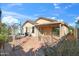Paver patio with view of the home's backyard, covered patio, and mature foliage at 3027 W Red Fox Rd, Phoenix, AZ 85083