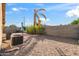 Gravel backyard with mature palm tree and block fence providing privacy to the home at 3027 W Red Fox Rd, Phoenix, AZ 85083