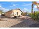 View of the backyard showing the extended covered patio, block wall and low maintenance landscaping at 3027 W Red Fox Rd, Phoenix, AZ 85083