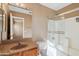 Bathroom featuring a granite sink, toilet, and shower with glass doors at 3027 W Red Fox Rd, Phoenix, AZ 85083