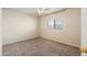Cozy bedroom featuring carpet floors, a ceiling fan, and a window at 3027 W Red Fox Rd, Phoenix, AZ 85083