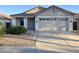 Charming single-story home featuring a tile roof, well-maintained landscaping, and an attached two-car garage at 3027 W Red Fox Rd, Phoenix, AZ 85083