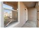 Close up of front porch with security door, a window with blinds, and an outdoor light fixture at 3027 W Red Fox Rd, Phoenix, AZ 85083