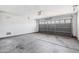 Spacious garage featuring concrete floors and a gray door at 3027 W Red Fox Rd, Phoenix, AZ 85083