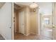 Hallway with tile flooring and neutral walls connecting multiple rooms at 3027 W Red Fox Rd, Phoenix, AZ 85083
