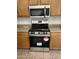 Kitchen features stainless steel oven and microwave, and light wood cabinets at 3027 W Red Fox Rd, Phoenix, AZ 85083