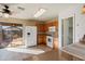 Bright kitchen featuring wood cabinets, white appliances, and sliding door access to the outdoor patio at 3027 W Red Fox Rd, Phoenix, AZ 85083