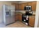 Functional kitchen featuring stainless steel appliances and ample wood cabinet storage space at 3027 W Red Fox Rd, Phoenix, AZ 85083