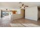 Open-concept living room with tile flooring, ceiling fan, and access to the kitchen and backyard at 3027 W Red Fox Rd, Phoenix, AZ 85083