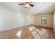 Spacious living room featuring tile flooring, ceiling fan, a window, and neutral wall color at 3027 W Red Fox Rd, Phoenix, AZ 85083