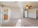 Large main bedroom featuring carpet floors, ceiling fan and a bathroom view at 3027 W Red Fox Rd, Phoenix, AZ 85083