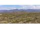 Sweeping aerial view of a community nestled within desert terrain and mountain scenery at 30434 N Palo Brea Dr, Scottsdale, AZ 85266