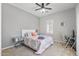 Bright bedroom featuring a comfortable bed, mirrored side tables, and a dedicated workspace at 30434 N Palo Brea Dr, Scottsdale, AZ 85266
