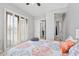 Light-filled bedroom with plantation shutters, connecting doors, and stylish patterned bedding at 30434 N Palo Brea Dr, Scottsdale, AZ 85266